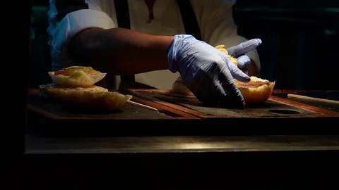 Cook Preparing Burger in Restaurant Stock Footage 106456537
