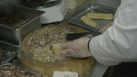 Cook Preparing Chopped Meat Street Food with Bread in Beijing Kitchen Stock Footage 345856178