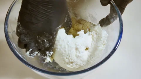 The cook is preparing cottage cheese cookie dough in a glass bowl. Stock Footage 315280029
