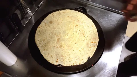 Cook preparing a crepe with cheese, Turkish sauge (sucuk) and egg, fast motion Stock Footage 103873006