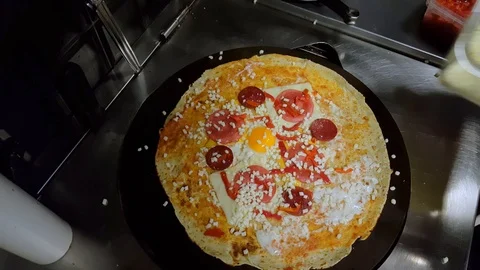 Cook preparing a crepe with cheese, Turkish sauge (sucuk) and egg Stock Footage 103877720