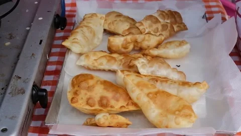 Cook preparing fried dumplings in a pan full of seed oil. Stock Footage 135901258