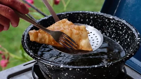Cook preparing fried dumplings in a pan full of seed oil. Stock Footage 135901400