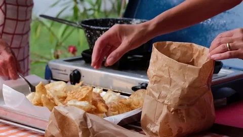 Cook preparing fried dumplings in a pan full of seed oil. Stock Footage 135901535