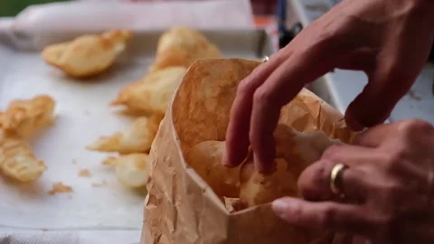 Cook preparing fried dumplings in a pan full of seed oil. Stock Footage 135901551