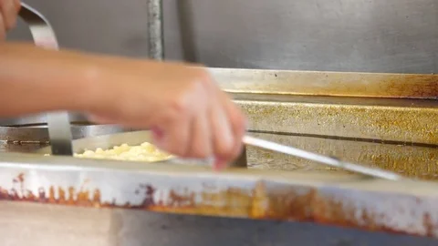 Cook preparing funnel cake in deep oil Stock Footage