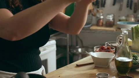 Cook preparing garlic using mortar and pestle on a cutting board for an octopus Stock Footage 199460424