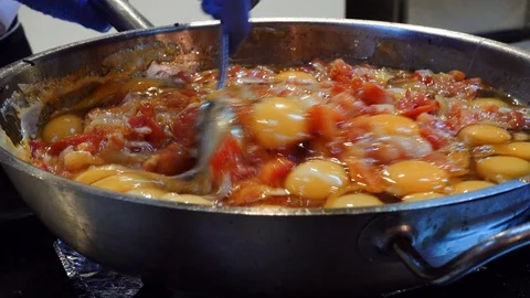 The cook is preparing an omelet for breakfast in a buffet restaurant. Stock Footage 101229715