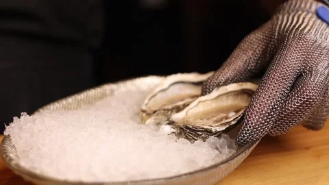 A cook preparing oysters in a restaurant Stock Footage 264949582