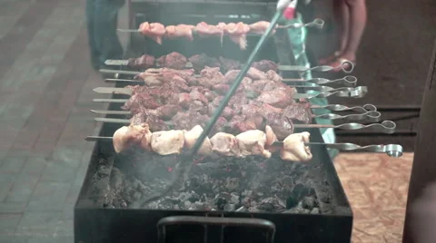 Cook preparing pieces of roasted shashlik beef meat on grill. Street food. Stock Footage 51173449