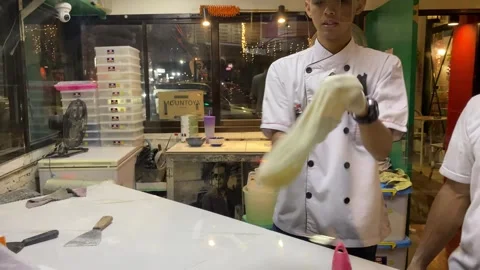 A cook is preparing the pizza dough Stockbeeldmateriaal 347544211