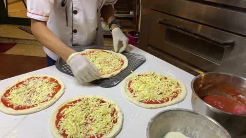 A cook is preparing the pizza dough Stock Footage 347544220