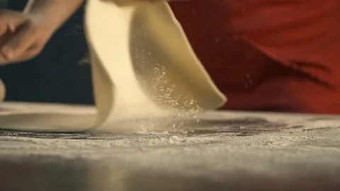 Cook preparing pizza dough. Slow Motion Stock Footage
