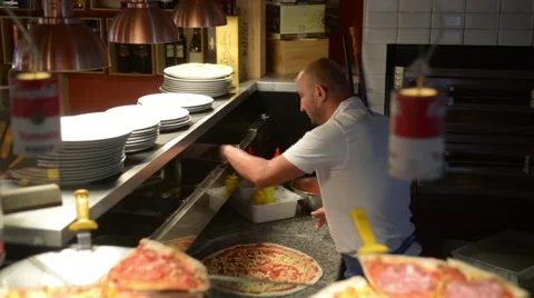 Cook preparing pizza dough in small cozy italian cafe Video stock 51885182