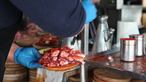 Cook preparing portion of Galician-style octopus Stock Footage 279252338