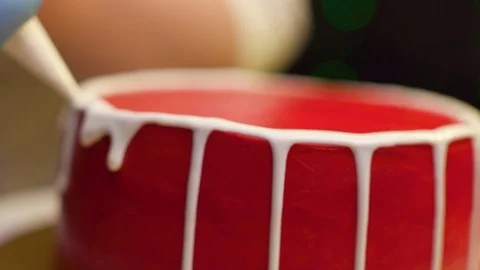 A cook is preparing a red cake for Christmas and New Year. 스톡 동영상 119856819