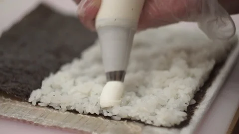 Cook preparing rolls. Cook adds cream cheese to rolls Stock Footage 106670114