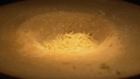 Cook preparing spaghetti in cheese Stock Footage 99541101