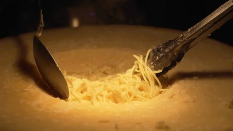 Cook preparing spaghetti in cheese Stock Footage 99541535