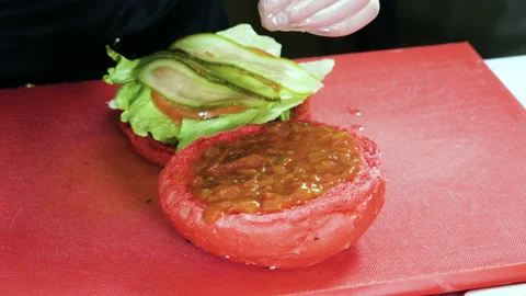 Cook preparing tasty burger with beef or pork rissole, smoked bacon, shrimps. 4K Stock-Footage 98034237