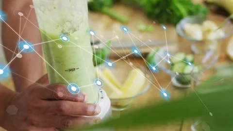 Cook pressing blender knob in kitchen, turning cucumber into green smoothie, Stockbeeldmateriaal 334760334
