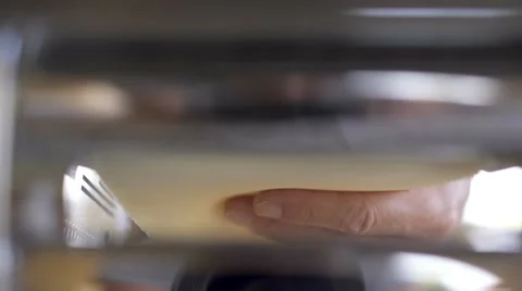 Cook pulling out the dough from a pasta machine. Stock Footage 67863525