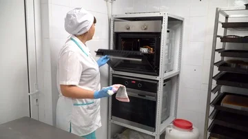 The cook pulls the cake out of the oven Stock Footage 85662047