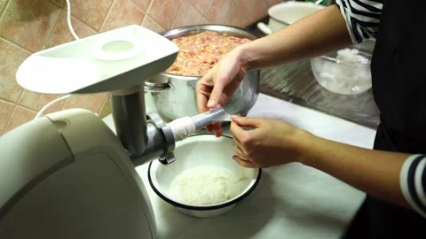 Cook pulls the intestine for stuffing the sausage on the nozzle of the electric Video stock 287897047