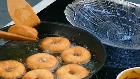 The cook pulls out a donut party Stock Footage 86119256