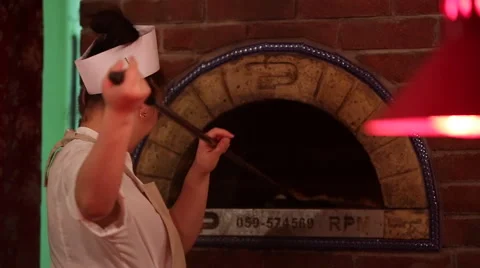 Cook pulls out of the oven ready pizza Stock Footage 44219041