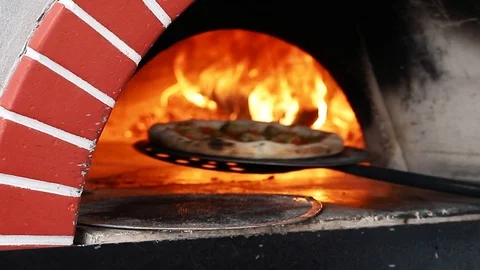 Cook pulls out of the oven ready pizza Stock Footage 121440237