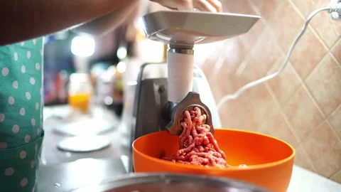 Cook pushes the meat in the meat grinder tray with a pusher Stock Footage 269451124