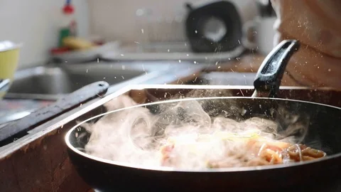 Cook put basil leafs on spaghetti with red tomato sauce in the frying pan. Stock Footage 100026151