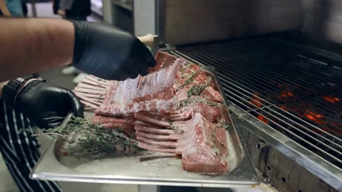 Cook put lamb on the grill. The chef cooks lamb on the grill. Stock Footage 145410434