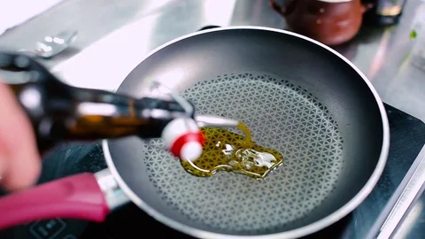 The cook put the oil on the pan Stock Footage 77667755