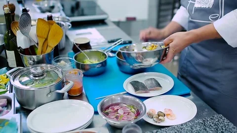 The cook put the salad into a pan Stock Footage 77710231
