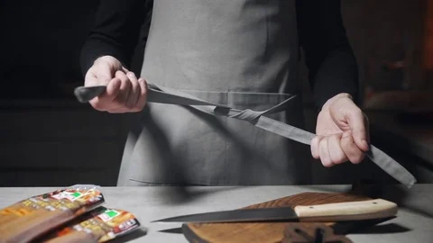The cook puts on the apron, preparations for cooking, kitchen stuff, food Stock Footage 75706130