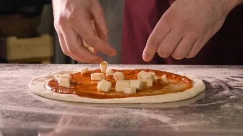 Cook puts cubes of cheese in pizza Video stock 107890775