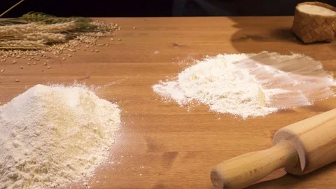 The cook puts the dough on a flour-poured table Stock Footage 77470804