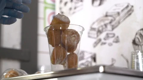 The cook puts the doughnuts in a package Stock Footage 128692164