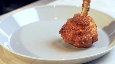 The cook puts fat, hot fried Crispy Chicken Drumsticks on the plate. Unhealthy. Stock-Footage 238507214