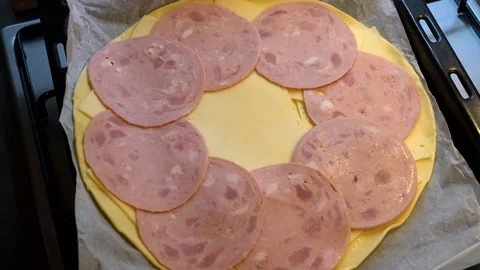 The cook puts ham on the dough with cheese Stock Footage 124435694