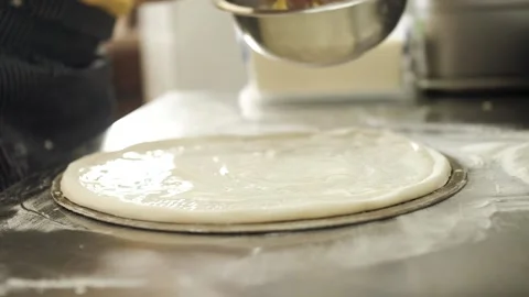 Cook puts his hands on the cheese on the pizza Stock Footage 130558228