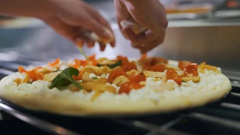 Cook puts ingredients on pizza close-up Stock Footage 128522337