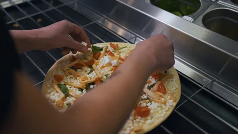 Cook puts ingredients on pizza Stock Footage 128522273
