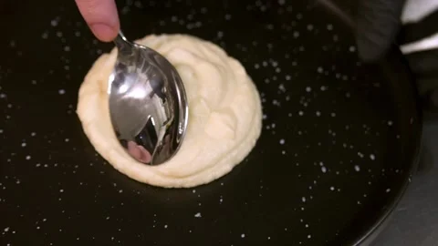 A cook puts mashed potatoes on a plate. Slow motion. Stock Footage 303745175