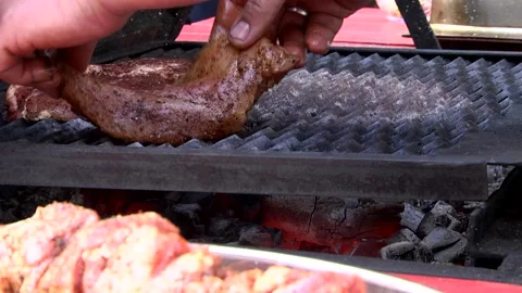Cook puts the meat on the grill. Stock Footage 133251618