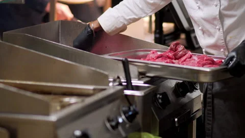 The cook puts the meat on the grill Stock Footage 235581152