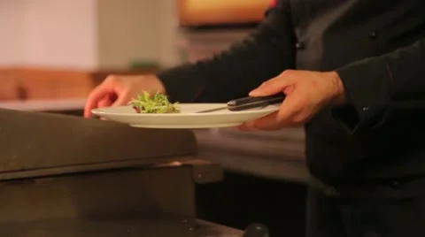 Cook puts meat grilled on a plate Stock Footage 61157696