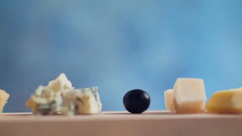 The cook puts olives and nuts on a cheese board Stock Footage 131419376